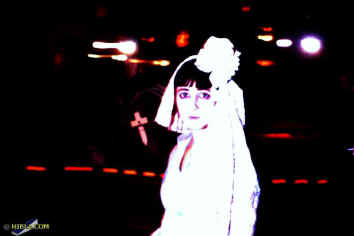  The lady in white: A lone bride in a pale blue wedding dress with a flowing full-length skirt and a giant lace turban garnished with a big white flower.  Enlarge Picture